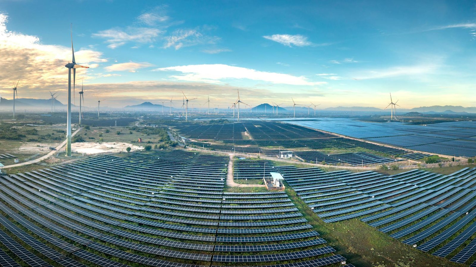 Panoramic aerial shot of a solar and wind farm in Vietnam showcasing renewable energy technologies.