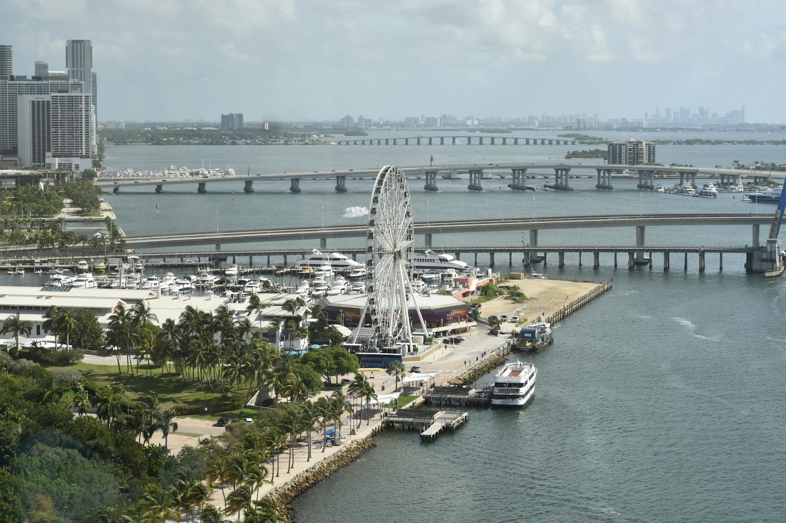 Aerial shot of Miami's Ferris Wheel and waterfront with bridges and city skyline in view.