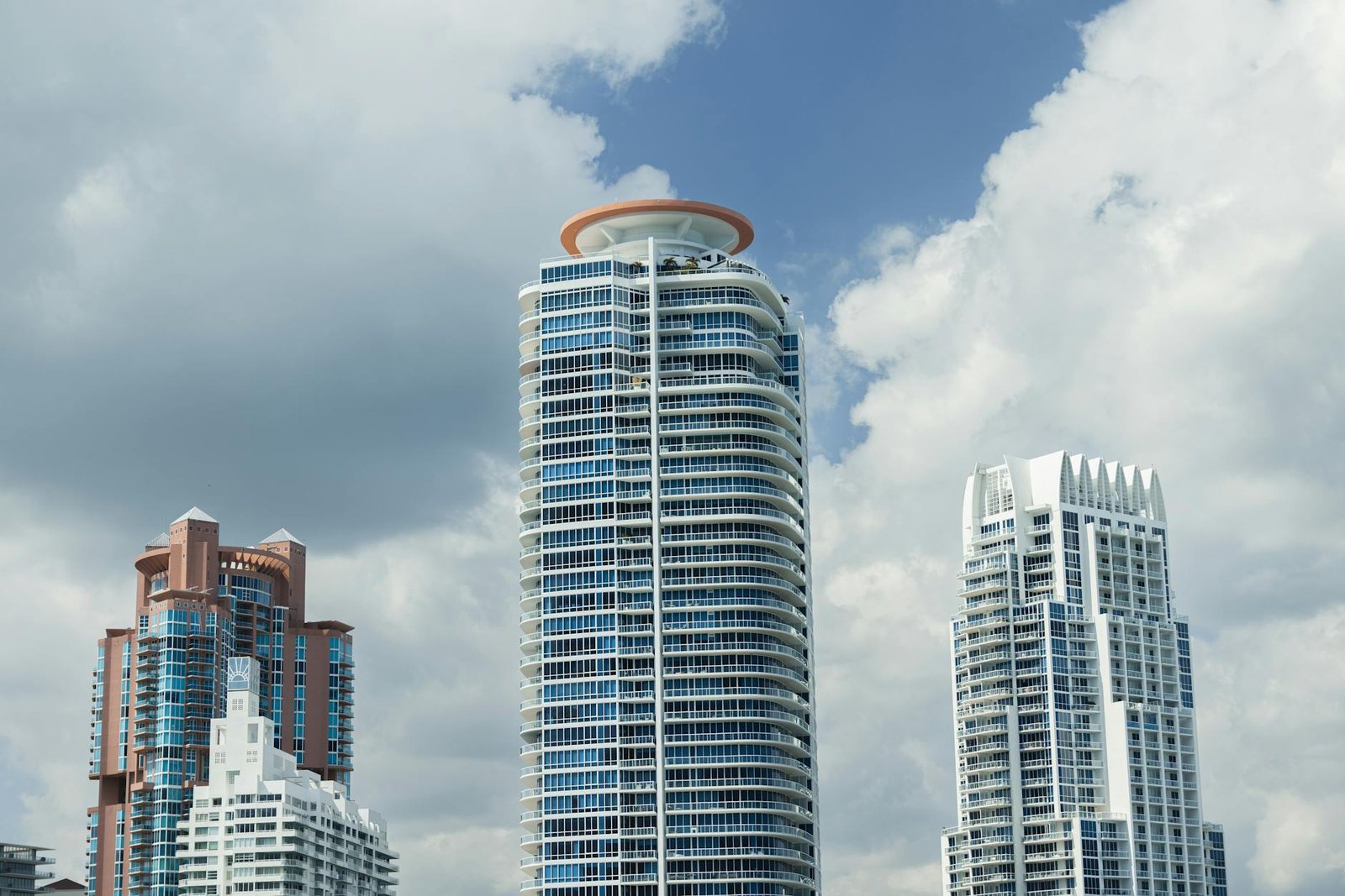 Captivating view of Miami's iconic modern skyscrapers under a bright, cloudy sky.