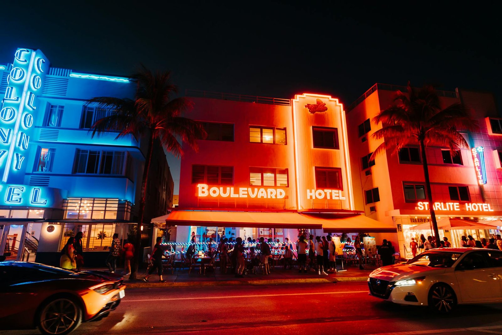 Captivating view of lit-up hotels and nightlife on Miami's Ocean Drive.
