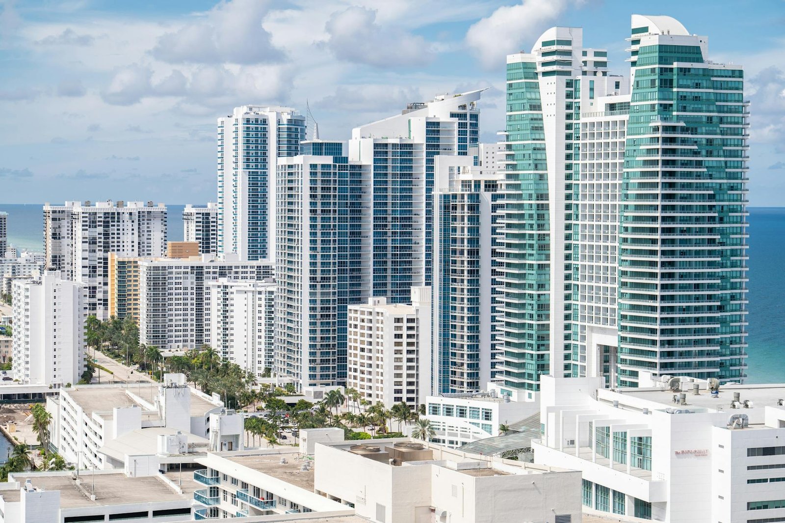 Aerial view of Hollywood, Florida's modern skyline along the coast with high-rise buildings and ocean views.
